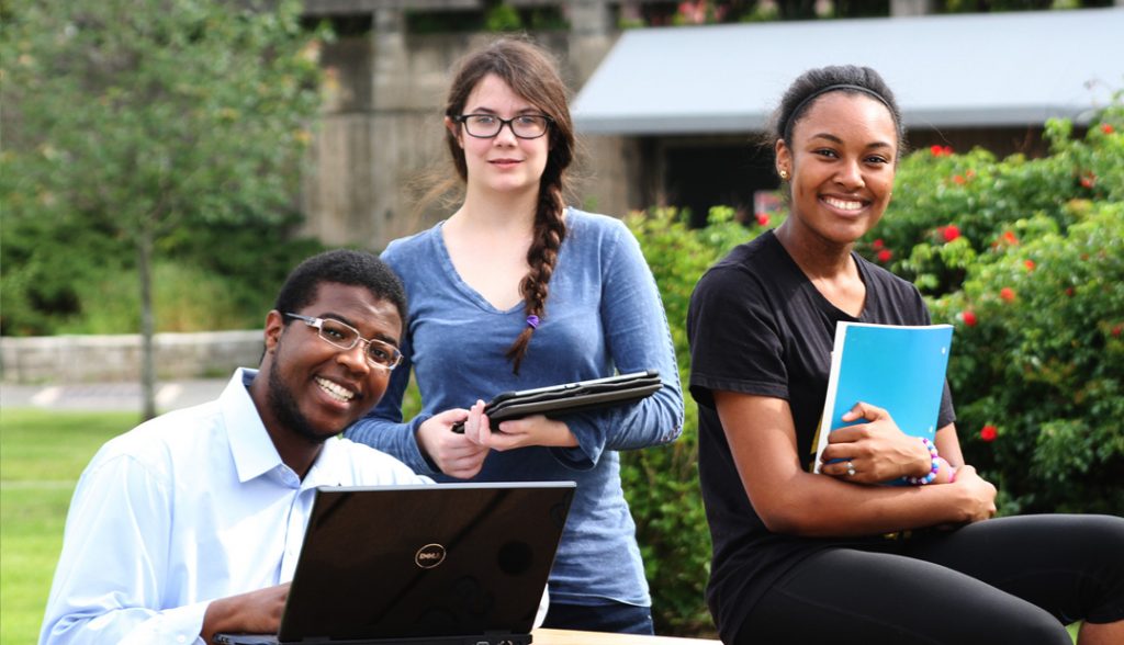 students in a group smiling at camera