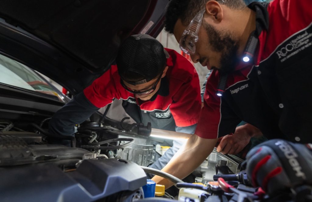 Students working on car