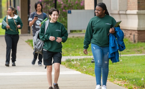 Two students walking on campus