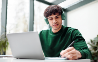 student on laptop, in home