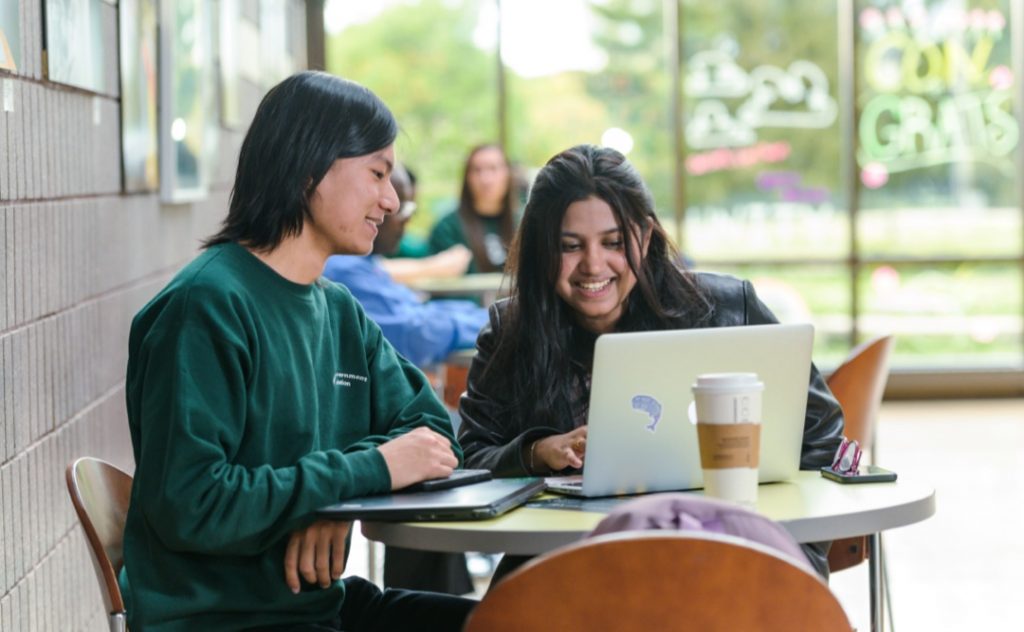 Two students looking at computer